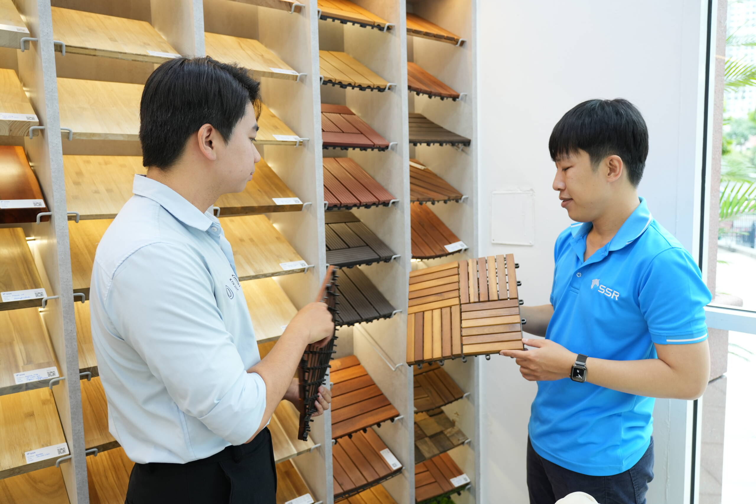 Comparing wood finishes for deck tiles in the showroom